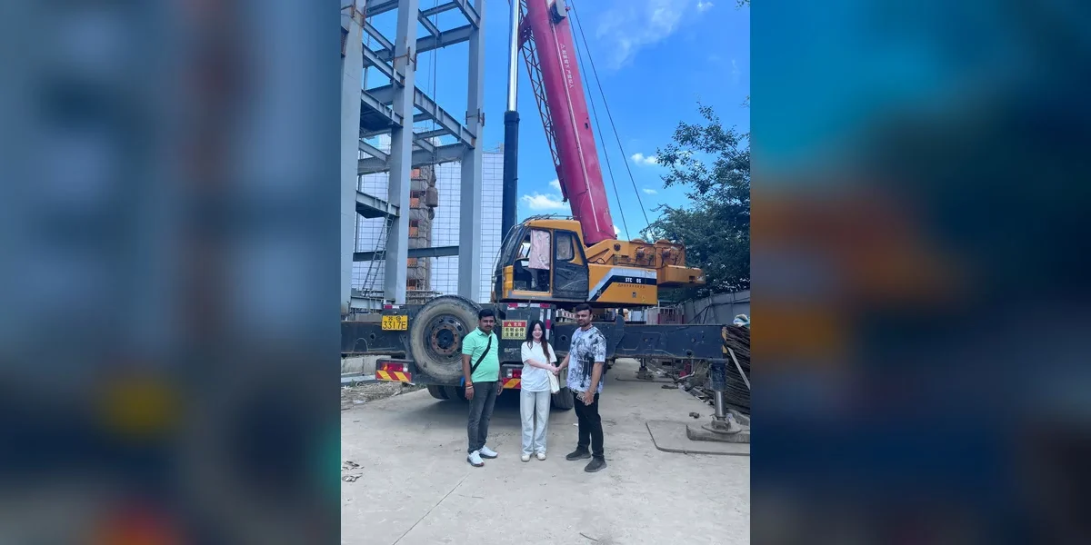 International buyers meeting the Kaihui Cranes team beside a mobile crane