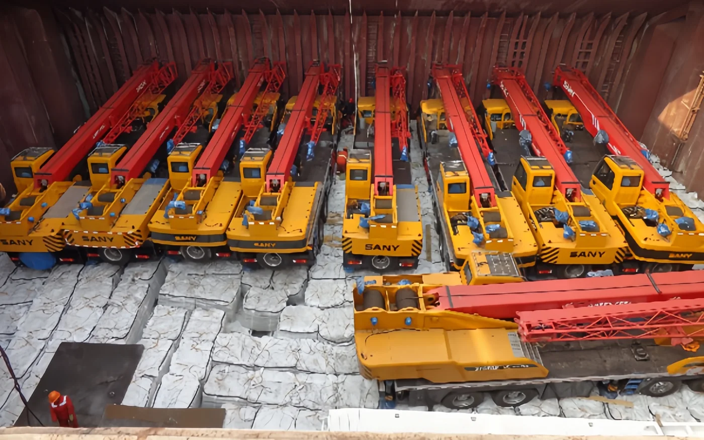 Multiple cranes loaded inside a cargo vessel